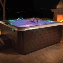 Hot Spring Highlife Collection Grandee Hot Tub -Outdoor Garden Living HotSpring Highlife 2018 Grandee Alpine White Mocha Lifestyle Couple Night 52116c4f cba9 41b6 8b13 e99a36da8fa5